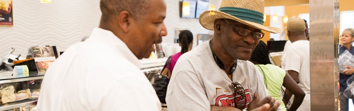 Photo of store employee helping customer.