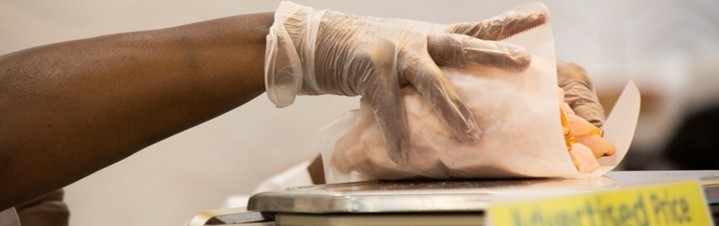Photo of deli meat being weighed for customer.